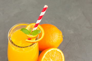Close-up of a glass of orange juice with oranges fruits