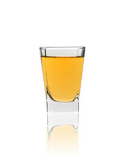 shot glass of whiskey isolated on white background with reflection