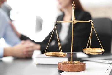 Scales of justice on table in lawyer's office