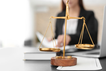 Scales of justice on table in lawyer's office