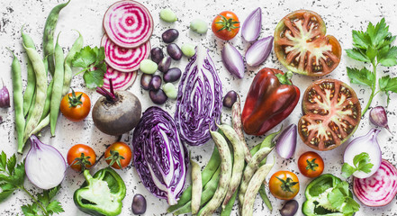 Fresh vegetables background. Cabbage, beets, green beans, tomatoes, peppers on a light background,...