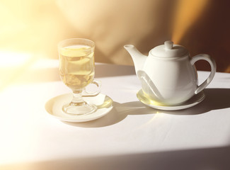 Retro photo of a glass of tea and a kettle