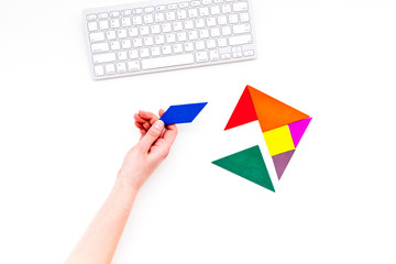 pieces of bright paper for puzzle on white office background top view mockup