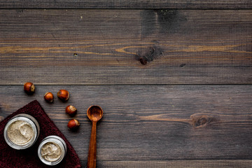 organic scrub with hazelnut for homemade spa on wooden background top view mockup