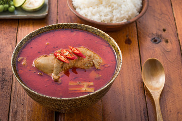 Thai food, chicken mussaman curry in a bowl and rice on wood

