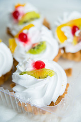 a set of pastries: cream puffs and fresh fruit