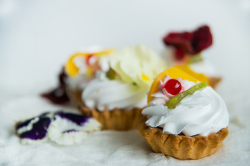 cake with fresh fruit and edible flowers Pansy Flowers on light background