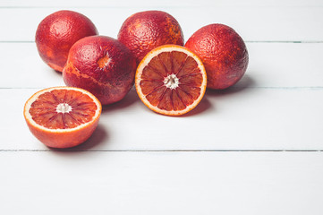 Blood oranges on a white wooden background. Seasonal citrus fruit