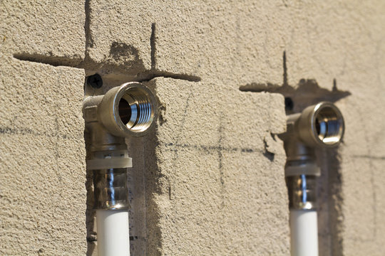 Water Pipes Made Of Polypropylene In The Wall, Plumbing In The House. Installation Of Sewer Pipes In A Bathroom Of An Apartment Interior During Renovation Works. Gray Plastic Drain Pipe For Used Water