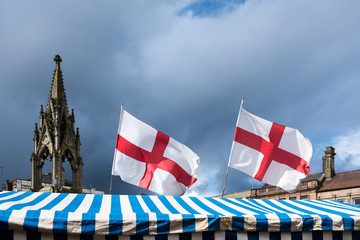 Mansfield in the county of Nottinghamshire ,English flags flying from a market stall on the market...