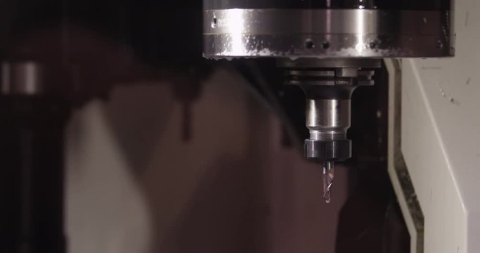 Close-up of a water jet metal cutting machine changing head.