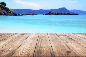 Wooden table with blue sea and beach background