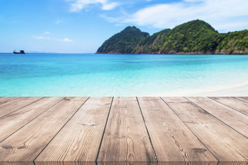 Wooden table with blue sea and beach background