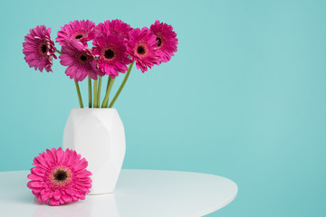 Dark pink gerberas in a vase on a retro table. Happy Mother's Day, Women's Day, Valentine's Day or...
