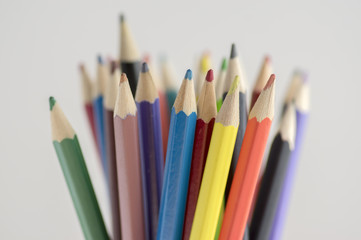 Close up of wooden colorful pencils, group of scattered crayons, isolated od white background