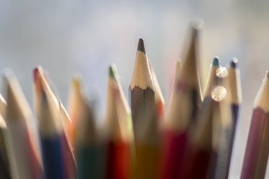 Close up of wooden colorful pencils, group of scattered crayons