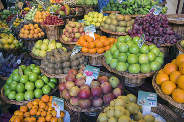 Various fruits on fruit market in Funchal, many types of passion fruit, prices