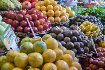 Various fruits on fruit market in Funchal, many types of passion fruit, prices
