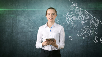 Woman standing near btc logo. Concept of virtual criptocurrency bitcoin dawnfall and correction.