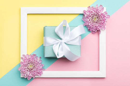 Happy Mother's Day, Women's Day, Valentine's Day or Birthday Pastel Candy Colours Background. Floral flat lay with beautiful present greeting card.