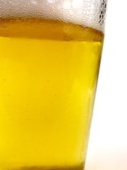 Close up of a glass of beer against a white background