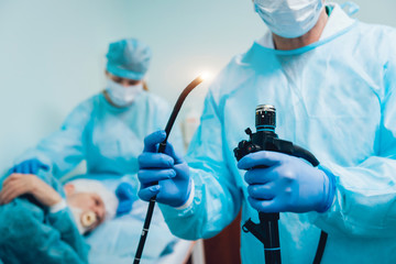 Endoscopy at the hospital. Doctor holding endoscope before gastroscopy - obrazy, fototapety, plakaty