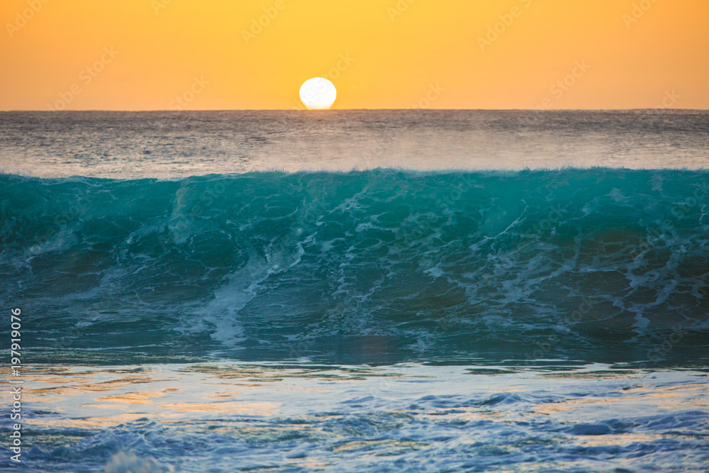Wall mural sunset background, big surfing ocean wave front view, tropical sea water