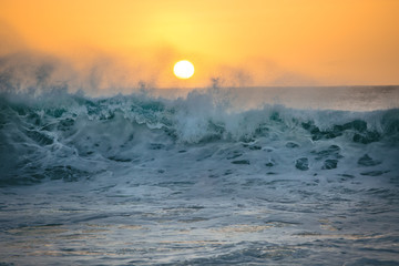 Ocean sunset and big crashing wave