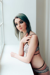 Naklejka premium beautiful girl in lingerie in a light interior