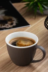 Fotobehang Hot americano coffee in gray cup on the table © torriphoto