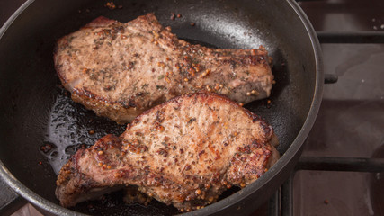grilled beef steak with rosemary, frying pan