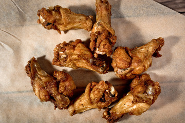 Bbq chicken wings on parchment paper.