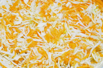 Obraz premium A background consisting of sliced ​​juicy cabbage and carrots.