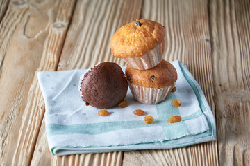 Tasty muffins arranged in pattern on light textured background, close-up, shallow depth of field, selective focus.