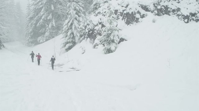 Wide shot of three young ladies hiking on a snowy day