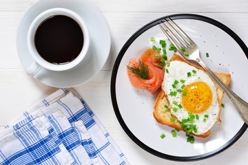 Morning breakfast: egg, toast, salmon and a cup of coffee.
