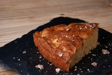 A piece of apple pie with grated chocolate near chocolate truffle candies. Selective focus and small depth of field.