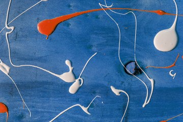 Artist working wooden table top with paint  marks spill all over the surface. Backgrounds...