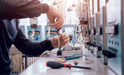 Electrician worker checking electricity meters. Electrical equipment.