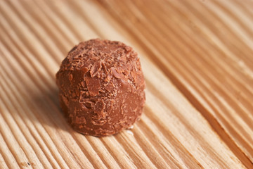 Macro. Chocolate candies on a light wooden background