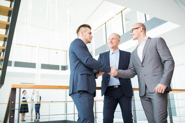Geschäftpartner schließen per Handschlag einen Vertrag