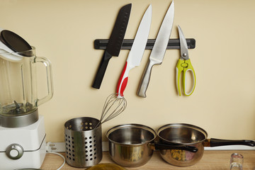 Kitchen utensils. Knives, pots, scissors, blender.
