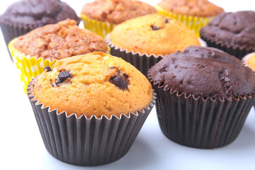 Assorted with Delicious homemade cupcakes with raisins and chocolate isolated on white background. Muffins. Top view.