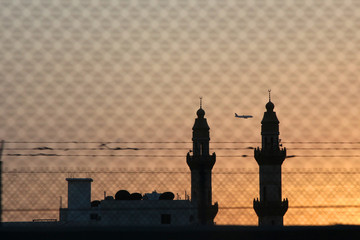 Fototapeta premium Red sunset with sun and silhouette of mosque minaret