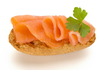 Bread with fresh salmon fillet isolated on white background, top view.