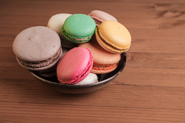 Colorful French macaron or Italian macaron stack on basket.