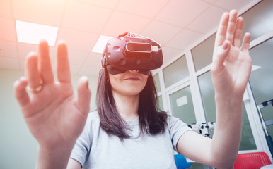 Eye treatment. Patient in virtual reality goggles. Checking the girl's vision with the help of...