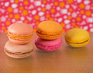 Stack of French colorful macarons on wooden background. Assorted traditional french dessert