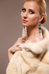 Portrait of beautyful woman with stylish professional make-up. Fashion photoshoot in fur jacket.