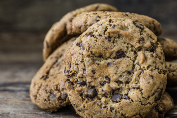 A Heap of Freshly Baked Chocolate Cookies on Rustic Wooden Table. Sweet Biscuits. Homemade pastry.